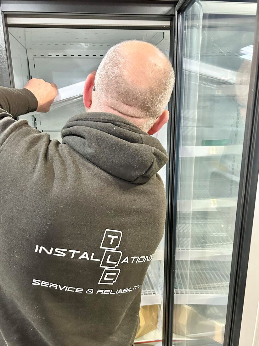 TLC engineer installing a refrigerated display cabinet