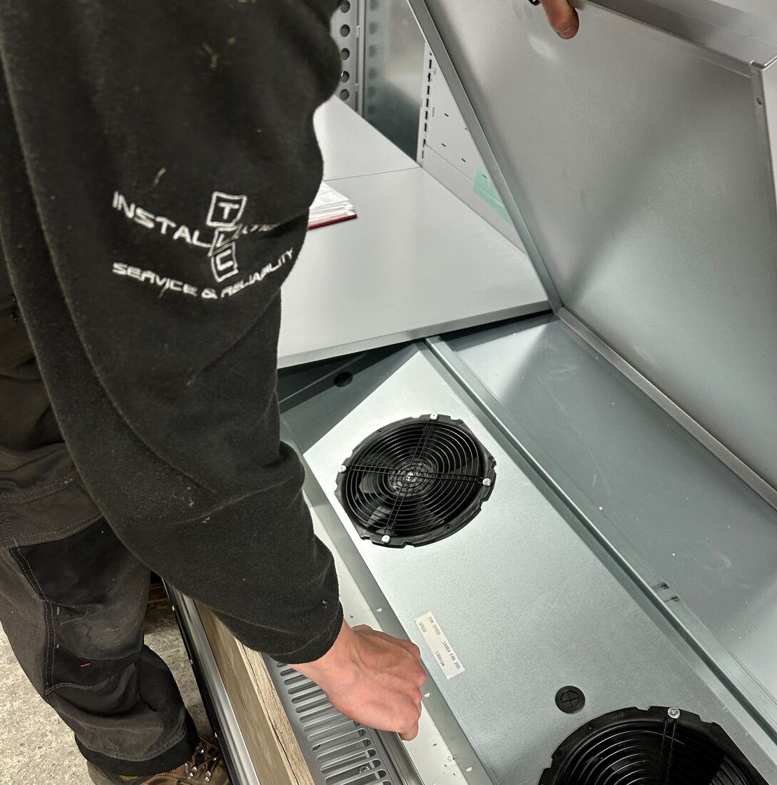 TLC technician servicing refrigeration equipment